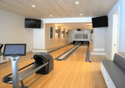 A home with a bowling alley and a tv.