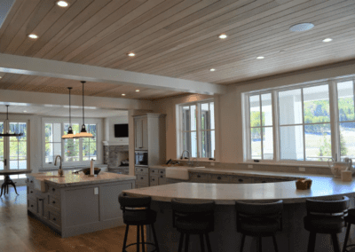 A kitchen with a center island and bar stools.