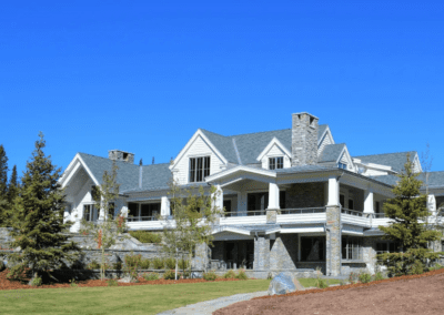 A large stone home with a large front porch.