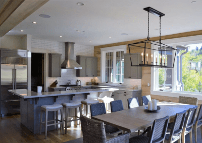 A large kitchen with a dining table and chairs.