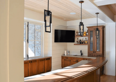 A kitchen with a bar and a tv.