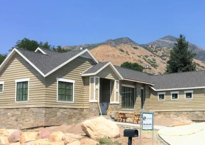 A home is being built in front of a mountain.